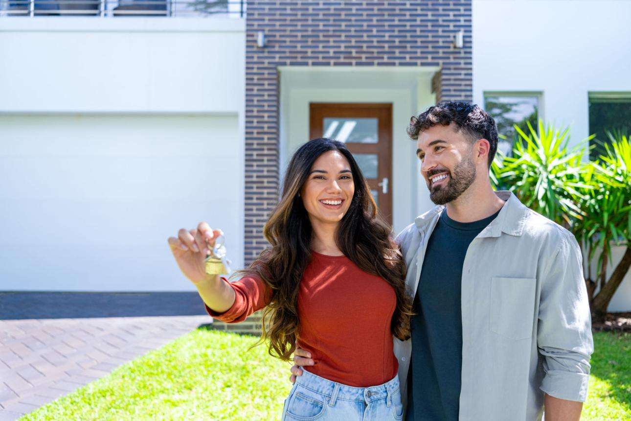 Happy couple with keys to new home